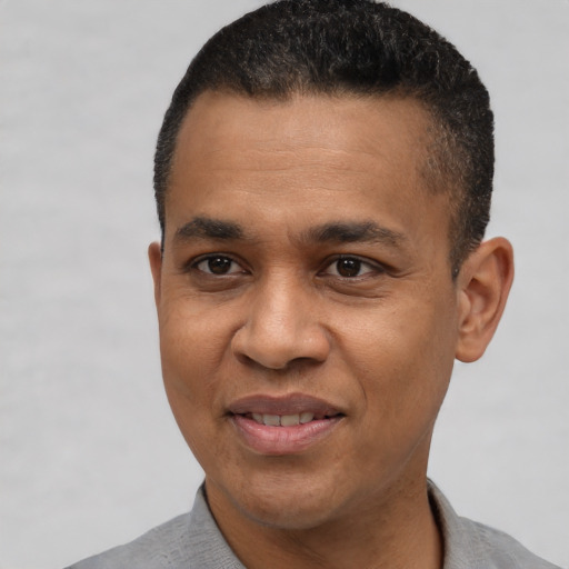 Joyful latino adult male with short  black hair and brown eyes