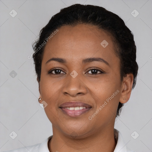 Joyful black young-adult female with short  black hair and brown eyes