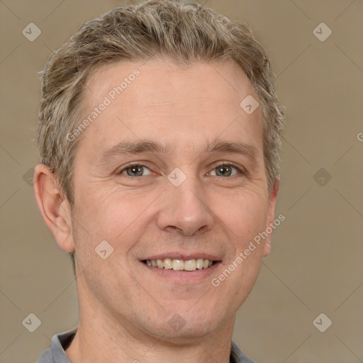 Joyful white adult male with short  brown hair and grey eyes