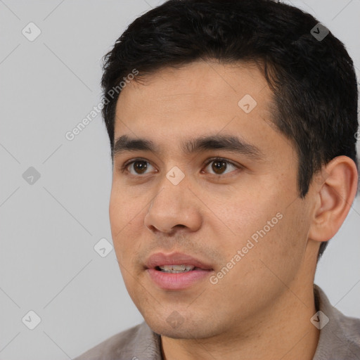 Joyful white young-adult male with short  black hair and brown eyes