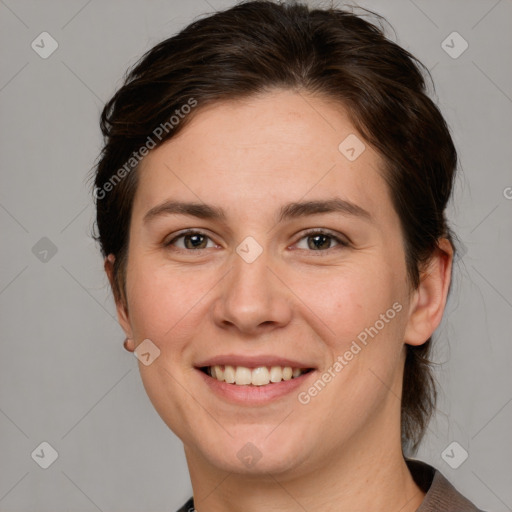 Joyful white young-adult female with medium  brown hair and grey eyes