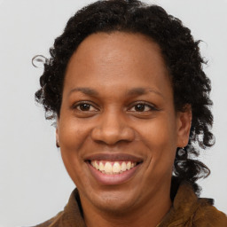 Joyful black adult female with long  brown hair and brown eyes