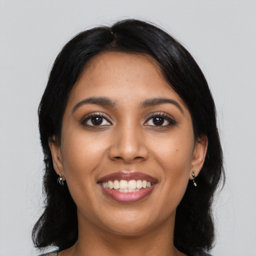 Joyful latino young-adult female with long  black hair and brown eyes