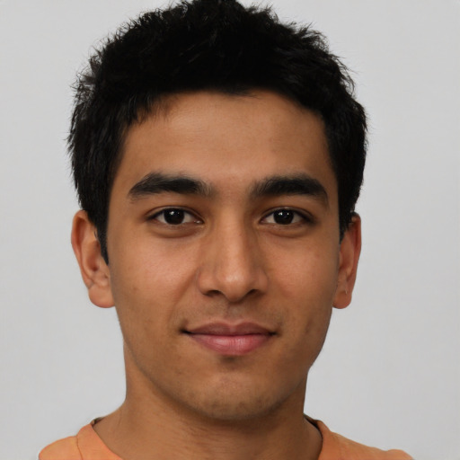 Joyful latino young-adult male with short  black hair and brown eyes