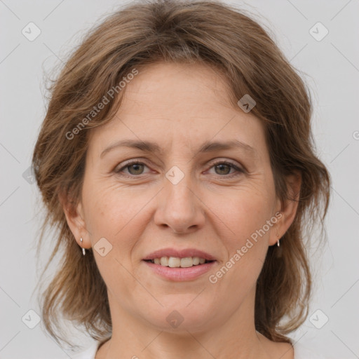 Joyful white adult female with medium  brown hair and grey eyes