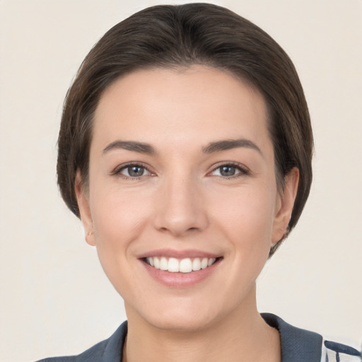 Joyful white young-adult female with short  brown hair and brown eyes