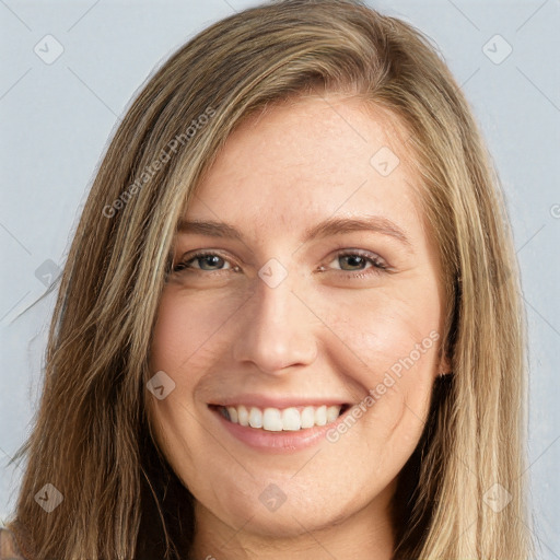 Joyful white young-adult female with long  brown hair and grey eyes