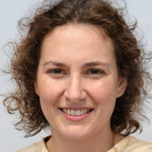 Joyful white adult female with medium  brown hair and brown eyes