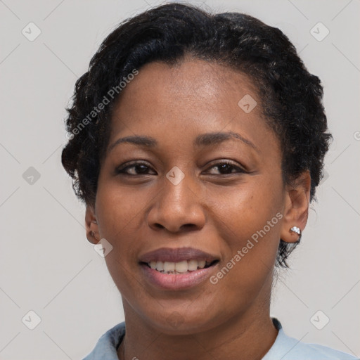 Joyful black young-adult female with short  black hair and brown eyes