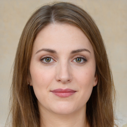 Joyful white young-adult female with long  brown hair and green eyes