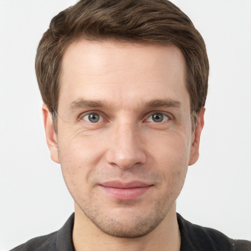 Joyful white adult male with short  brown hair and grey eyes