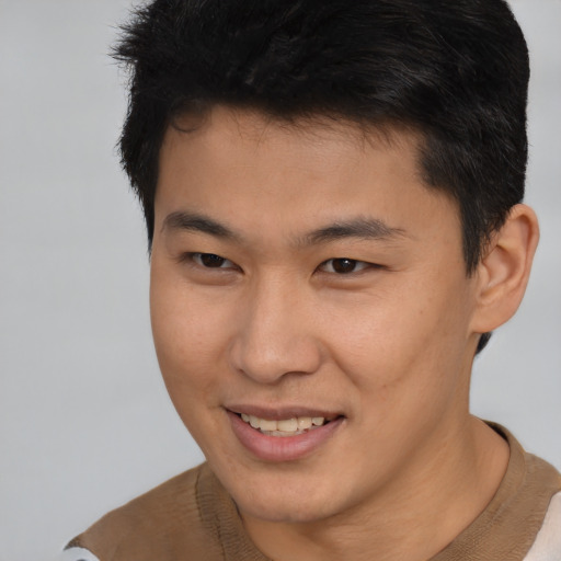 Joyful asian young-adult male with short  brown hair and brown eyes