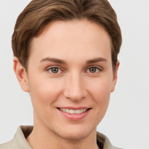 Joyful white young-adult female with short  brown hair and grey eyes