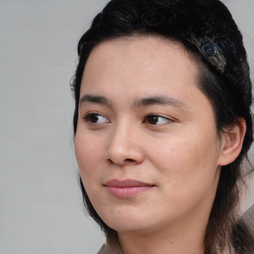 Joyful white young-adult female with medium  black hair and brown eyes