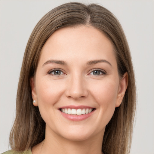 Joyful white young-adult female with long  brown hair and grey eyes