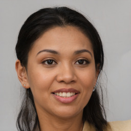 Joyful latino young-adult female with long  brown hair and brown eyes