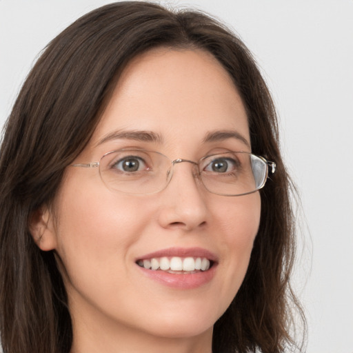 Joyful white young-adult female with medium  brown hair and grey eyes