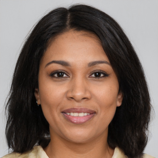 Joyful latino young-adult female with long  brown hair and brown eyes