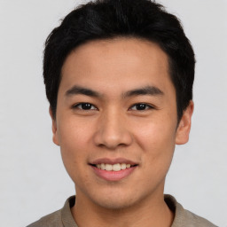 Joyful asian young-adult male with short  black hair and brown eyes