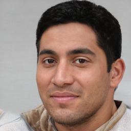 Joyful white young-adult male with short  black hair and brown eyes