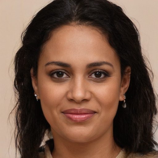 Joyful latino young-adult female with long  brown hair and brown eyes