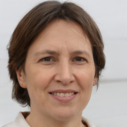 Joyful white adult female with medium  brown hair and brown eyes