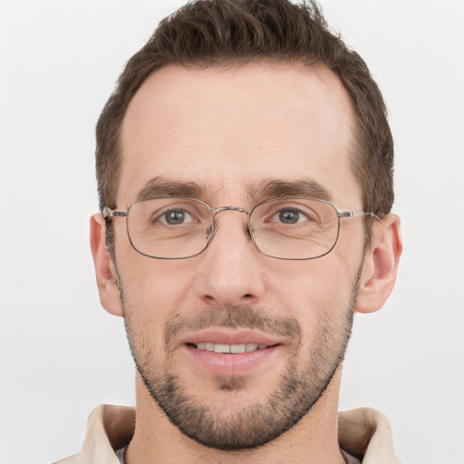 Joyful white adult male with short  brown hair and grey eyes