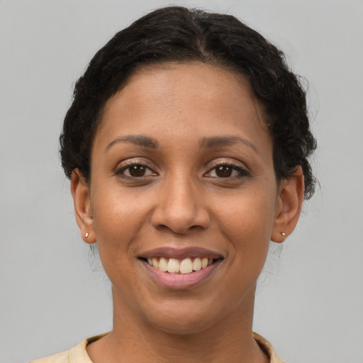Joyful latino young-adult female with short  brown hair and brown eyes