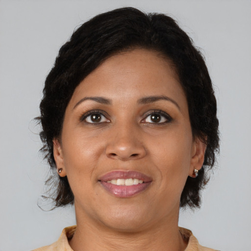 Joyful black adult female with medium  brown hair and brown eyes