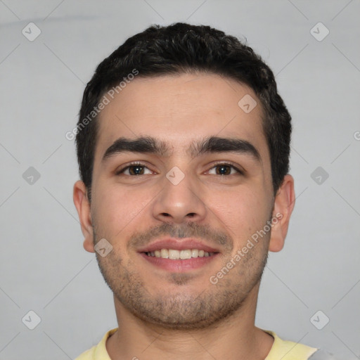 Joyful white young-adult male with short  black hair and brown eyes