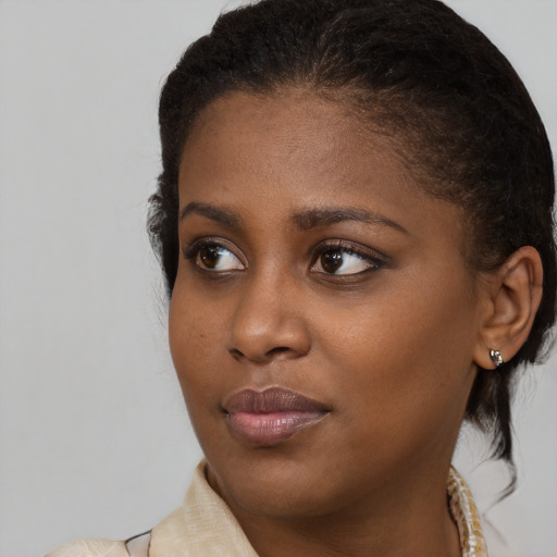 Joyful black young-adult female with medium  brown hair and brown eyes