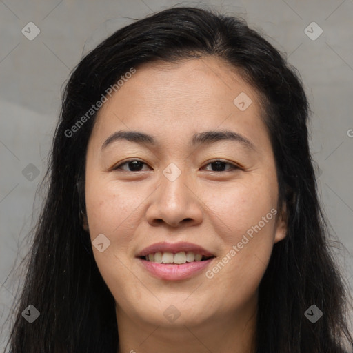 Joyful asian young-adult female with long  brown hair and brown eyes