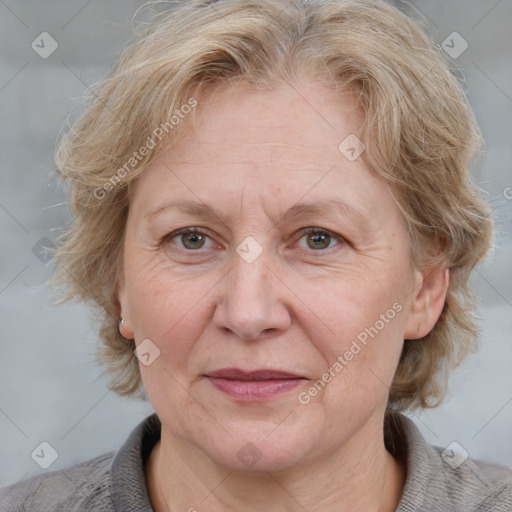 Joyful white adult female with medium  brown hair and blue eyes