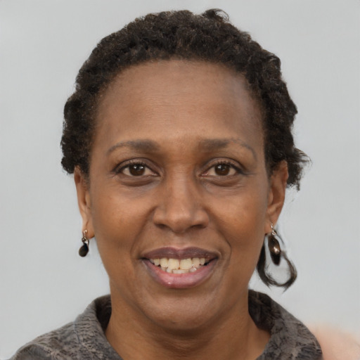 Joyful latino adult female with short  brown hair and brown eyes