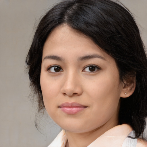 Joyful asian young-adult female with medium  brown hair and brown eyes