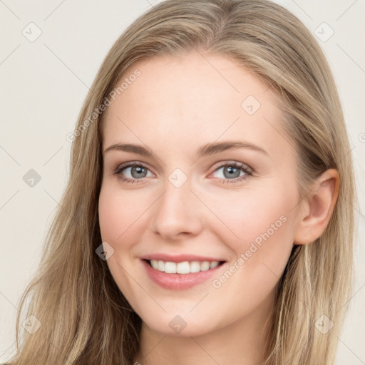 Joyful white young-adult female with long  brown hair and blue eyes