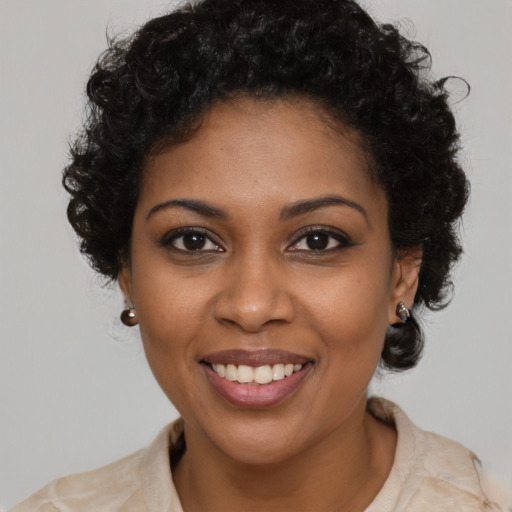 Joyful black young-adult female with short  brown hair and brown eyes