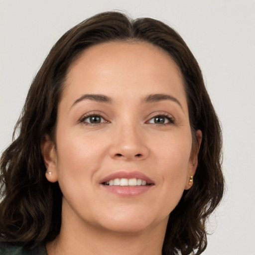 Joyful white young-adult female with long  brown hair and brown eyes