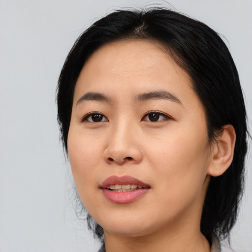 Joyful asian young-adult female with medium  black hair and brown eyes