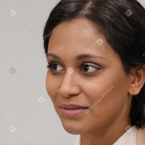 Joyful latino young-adult female with medium  brown hair and brown eyes