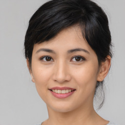 Joyful asian young-adult female with medium  black hair and brown eyes