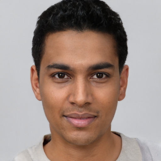 Joyful latino young-adult male with short  black hair and brown eyes