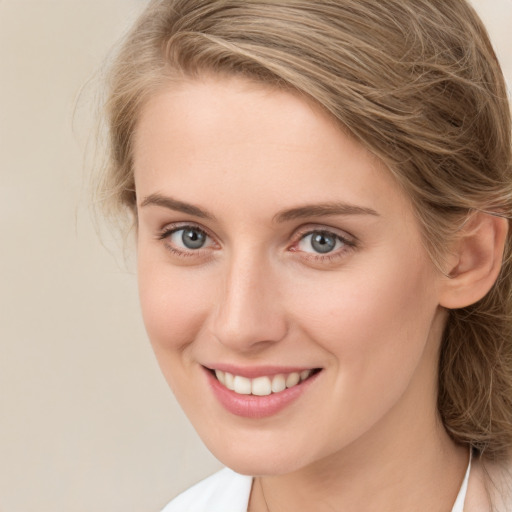 Joyful white young-adult female with long  brown hair and green eyes