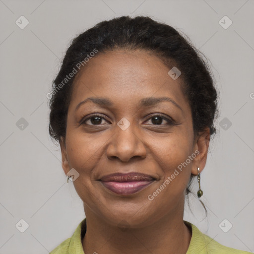 Joyful black adult female with medium  brown hair and brown eyes