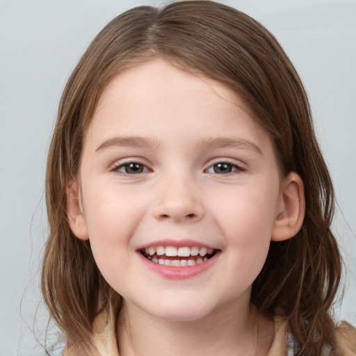 Joyful white child female with medium  brown hair and grey eyes