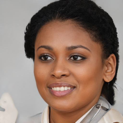 Joyful black young-adult female with medium  brown hair and brown eyes