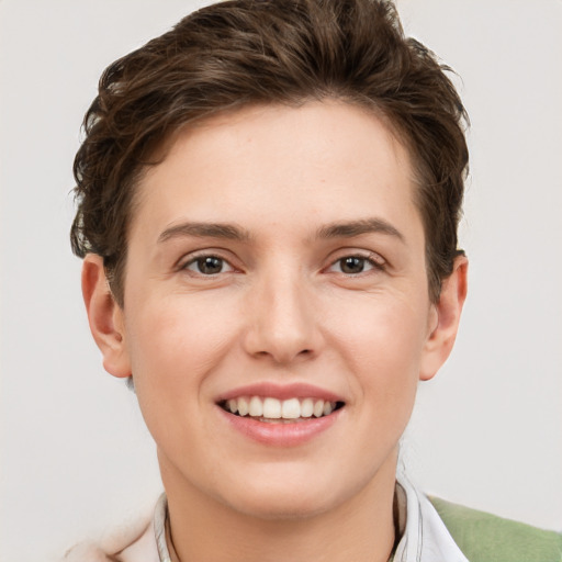 Joyful white young-adult female with short  brown hair and grey eyes