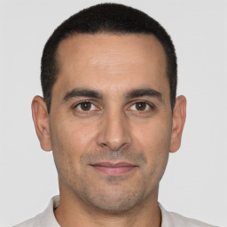 Joyful white young-adult male with short  black hair and brown eyes