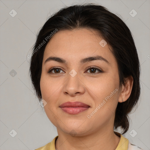 Joyful latino young-adult female with medium  brown hair and brown eyes