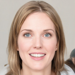 Joyful white young-adult female with medium  brown hair and blue eyes